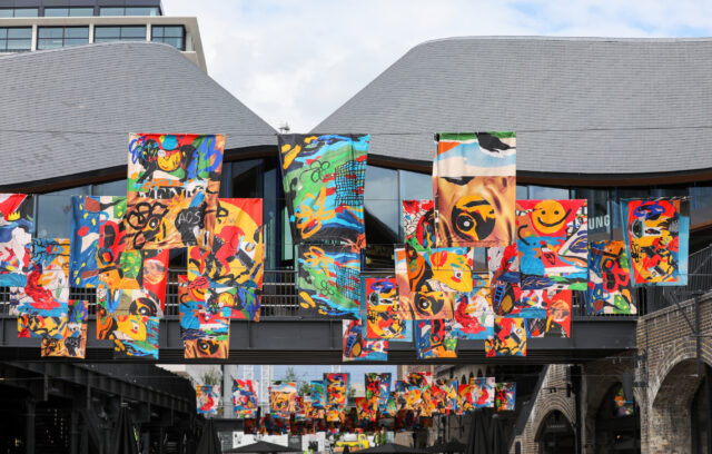 'All Our Stories' Flag art installation in Cole Drops Yard, desi