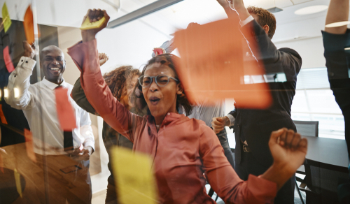 Diverse,Group,Of,Ecstatic,Businesspeople,Cheering,Together,Over,A,Winning