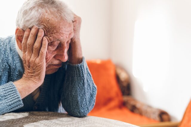Older man head in hands