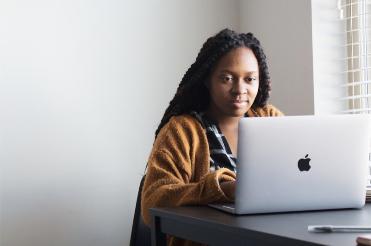 A person taking an online training course on a laptop at a desk