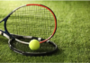 Two tennis rackets and a yellow ball resting on grass, illustrating Wimbledon’s grass-court tradition