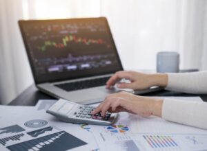 Investor analyzing financial charts and calculating portfolio risk